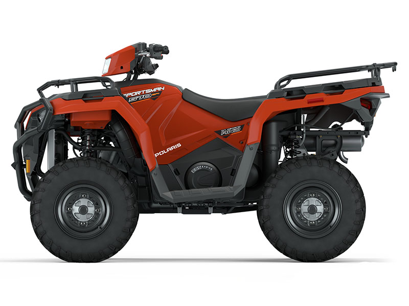 A side view of a red Polaris Sportsman 570 all-terrain vehicle (ATV) with black seats, large off-road tires, and front and rear cargo racks.